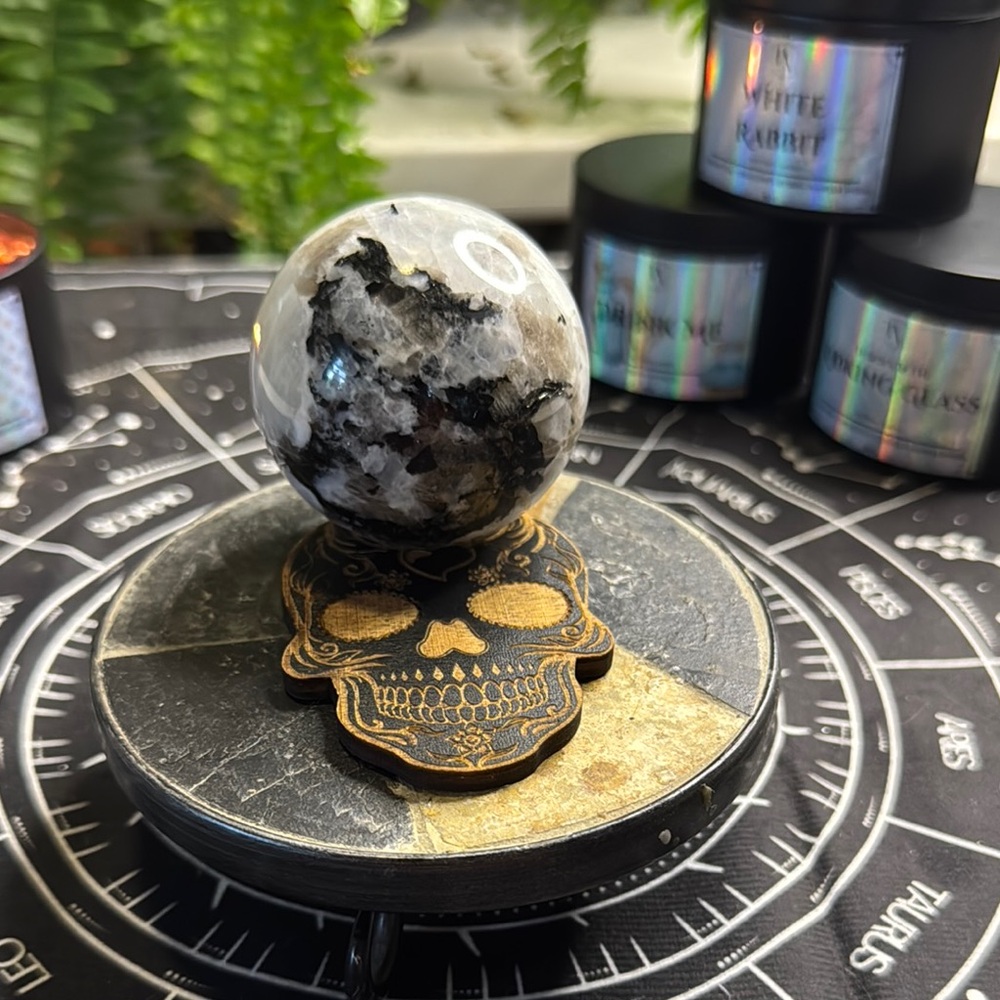 Polished Black and White Crystal Sphere on Decorative Skull Stand